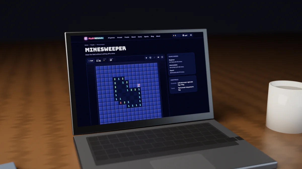 A laptop on a wooden desk showing a game of Minesweeper in progress on PlayNovarc, with a cup of coffee beside it